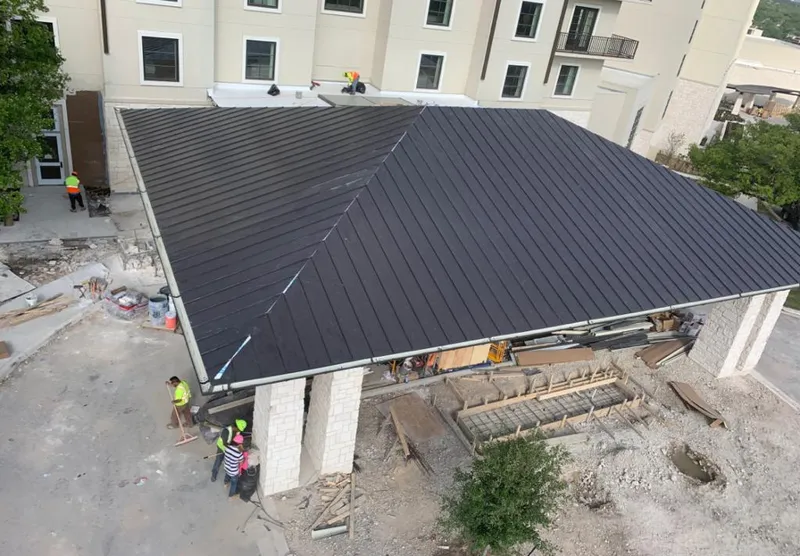 Metal roofing installation team working on a commercial building in Airmont